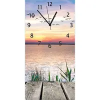 Wallario Design Wanduhr Seepanorama mit Schilf und fliegenden Vögeln aus Echtglas, Größe 30 x 60 cm