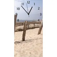 Wallario Design Wanduhr Sandstrand mit Holzpfählen am Atlantischen Ozean aus Echtglas, Größe 30 x 60 cm