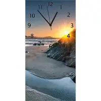 Wallario Design Wanduhr Sonnenuntergang hinter einem Felsen am Strand aus Echtglas, Größe 30 x 60 cm