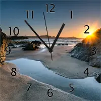 Wallario Design Wanduhr Sonnenuntergang hinter einem Felsen am Strand aus Echtglas, Größe 30 x 30 cm