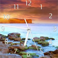 Wallario Design Wanduhr Sonnenaufgang am Meer mit Landzunge und Felsen im Wasser aus Echtglas, Größe 20 x 20 cm